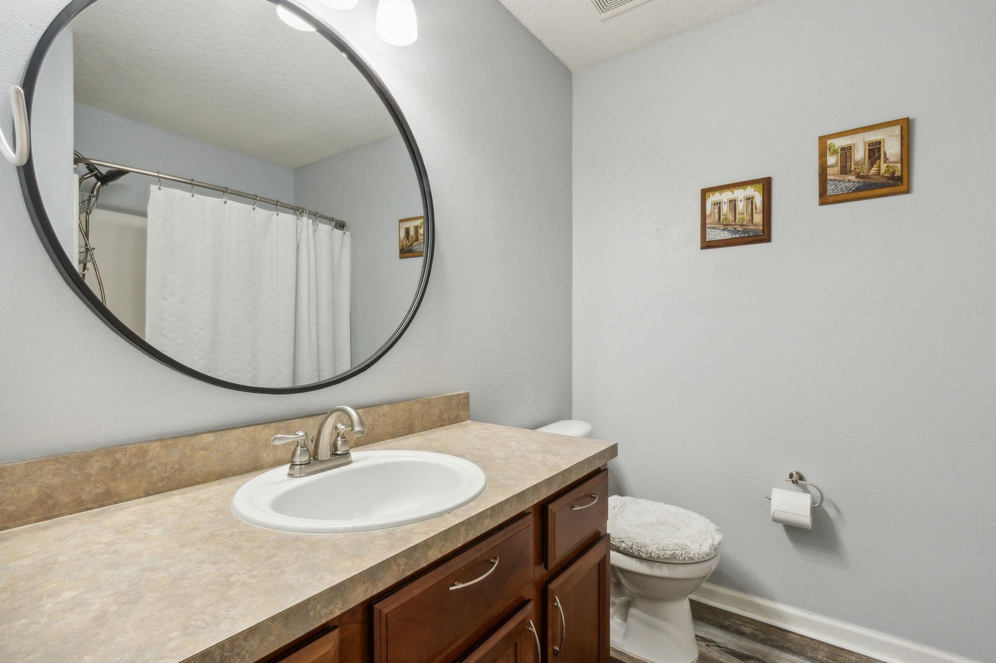 404 Golden Lake Loop St. Augustine, FL 32084 - Photo 24 of 38 a bathroom with a toilet a sink and mirror