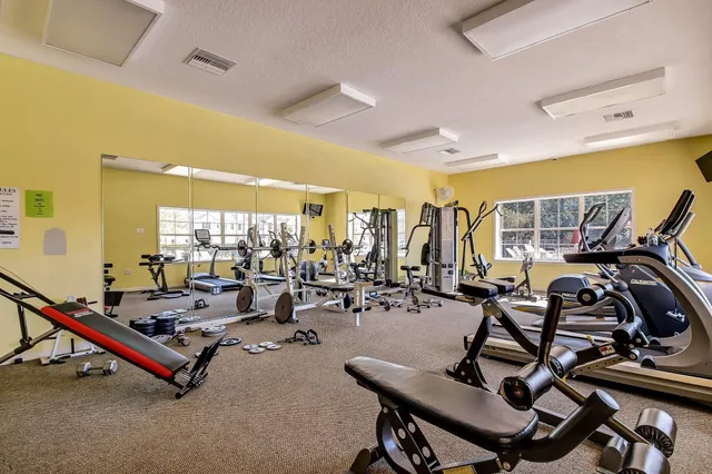 a room with gym equipment and windows