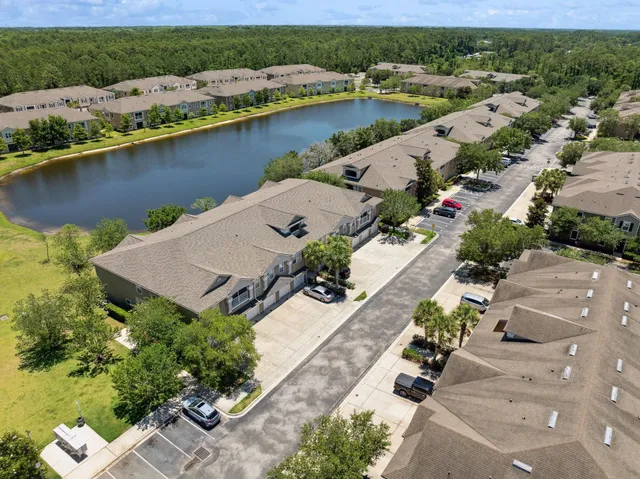 an aerial view of a house with a lake view