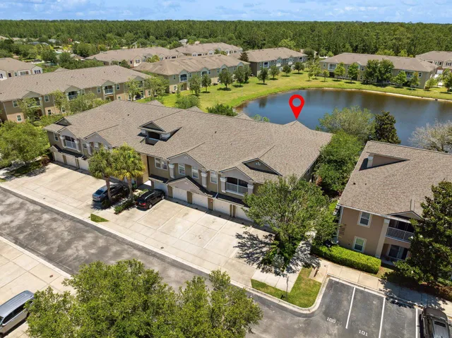 an aerial view of a house with a lake view