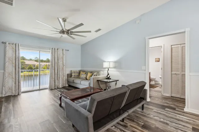 a living room with a bed furniture and a large window
