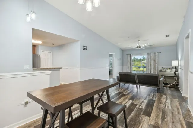 a view of a dining room with furniture and wooden floor