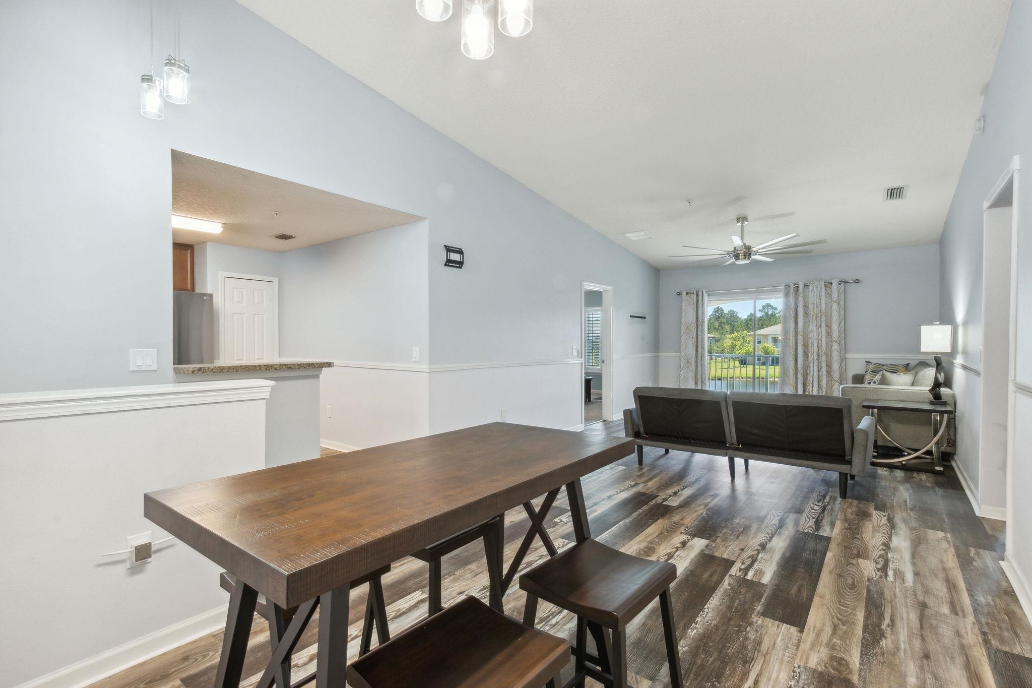 404 Golden Lake Loop St. Augustine, FL 32084 - Photo 9 of 38 a view of a dining room with furniture and wooden floor