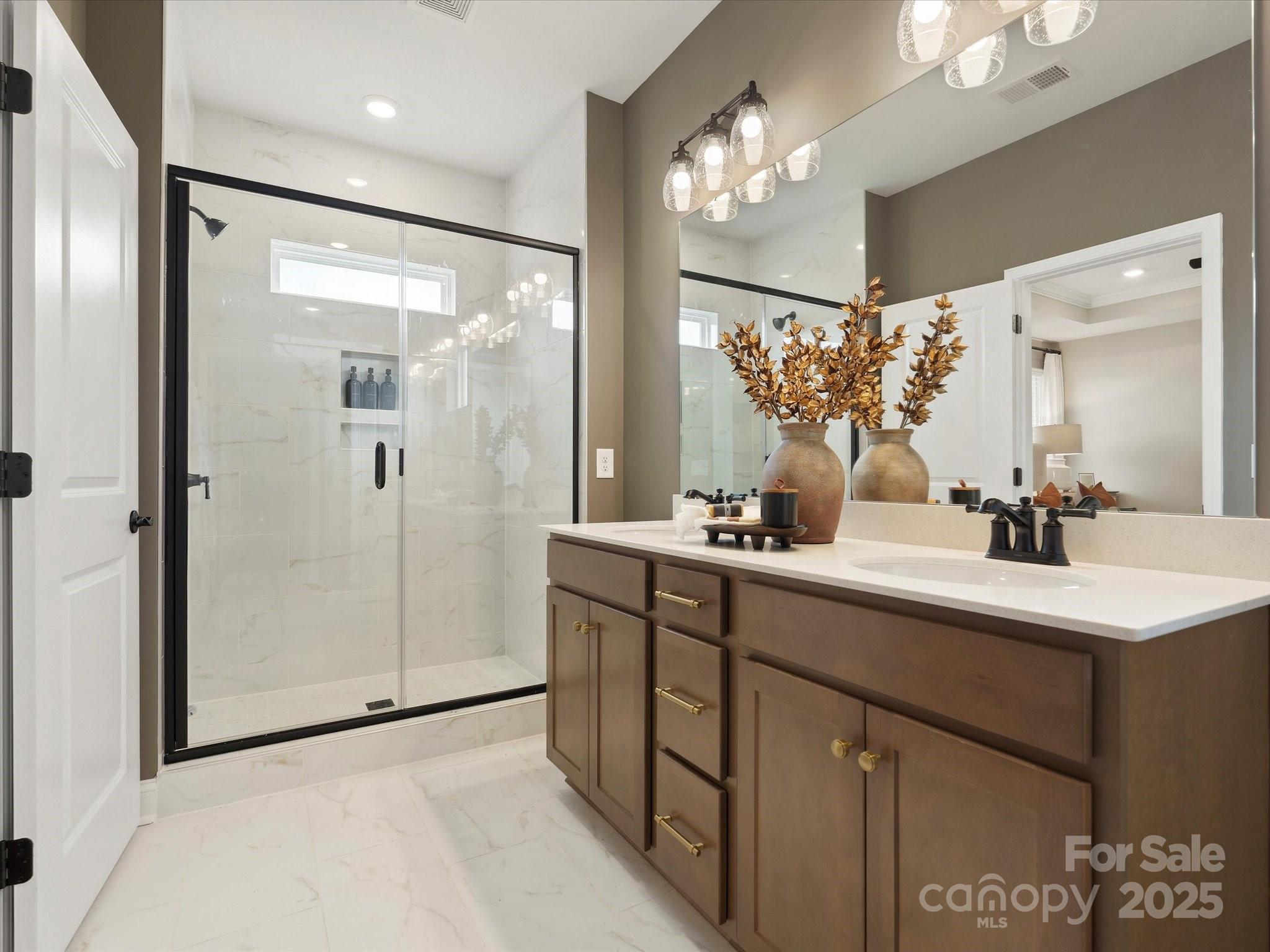 5061 Puddle Pond Road Indian Trail, NC 28079 - Photo 14 of 25 a bathroom with a double vanity sink mirror and shower