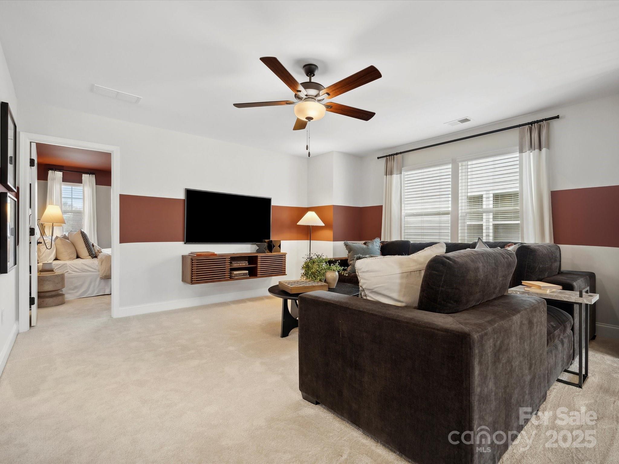 5061 Puddle Pond Road Indian Trail, NC 28079 - Photo 18 of 25 a living room with furniture and a flat screen tv