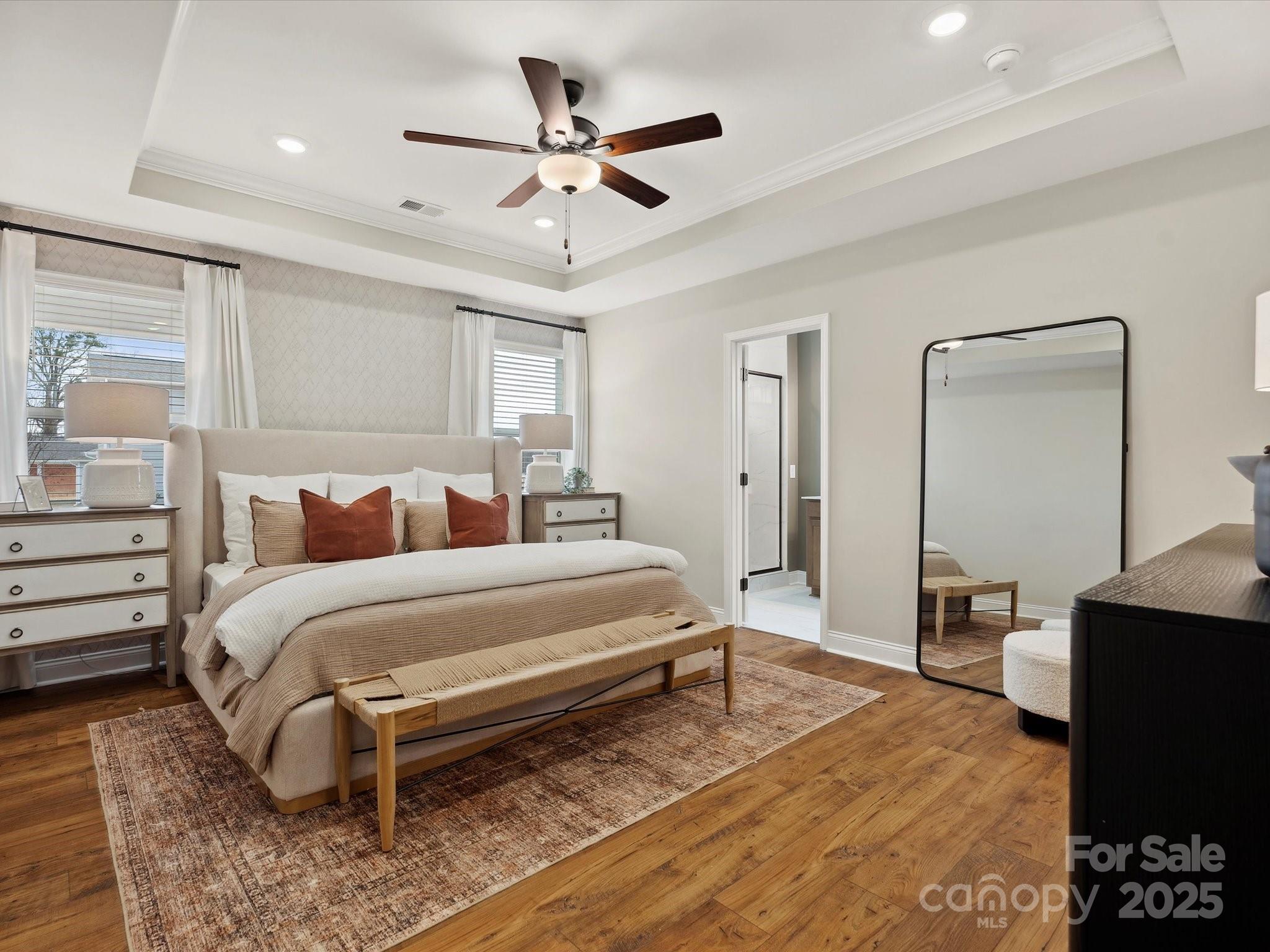5061 Puddle Pond Road Indian Trail, NC 28079 - Photo 10 of 25 a spacious bedroom with a bed a dresser and potted plant
