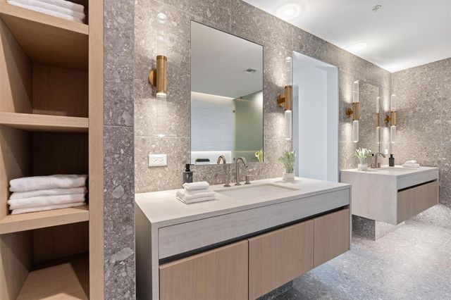 a bathroom with a sink double vanity and a mirror