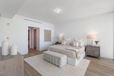 a bedroom with a bed and a lamp