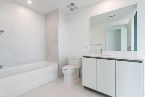 a bathroom with a sink a toilet and bathtub