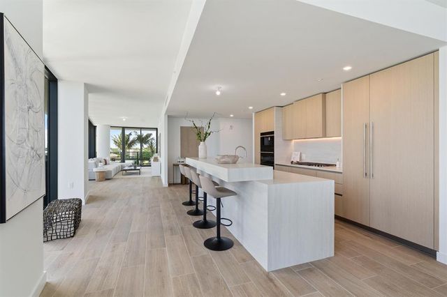 a kitchen with stainless steel appliances a refrigerator and a sink