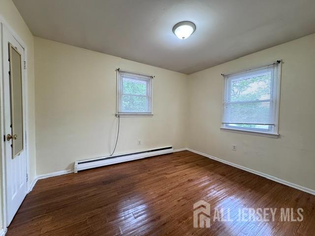 760 Mary Street, Unit B Perth Amboy, NJ 08861 - Photo 8 of 10 a view of an empty room with wooden floor and a window