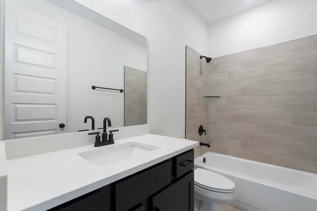 a front view of a house with yard and green space