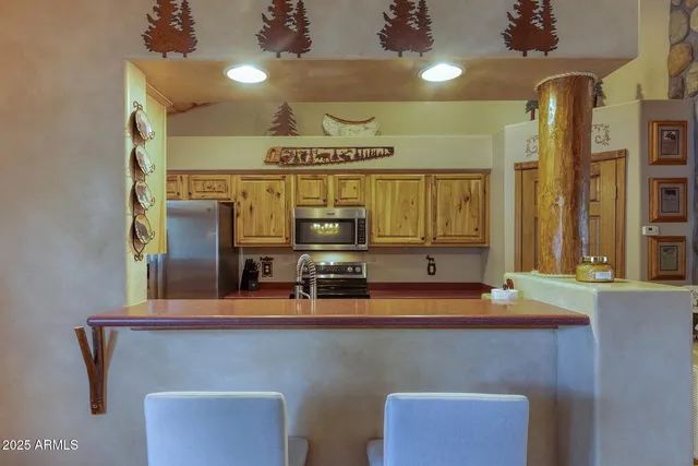 a kitchen with stainless steel appliances granite countertop a stove a sink dishwasher and a refrigerator