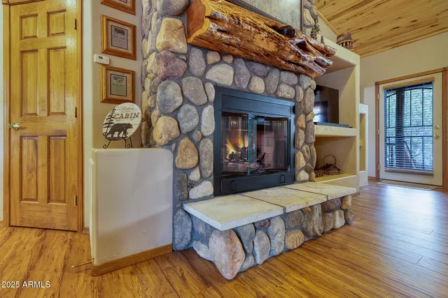 a living room with furniture flat screen tv and fireplace