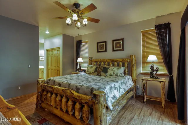 a bedroom with a large bed and a chandelier