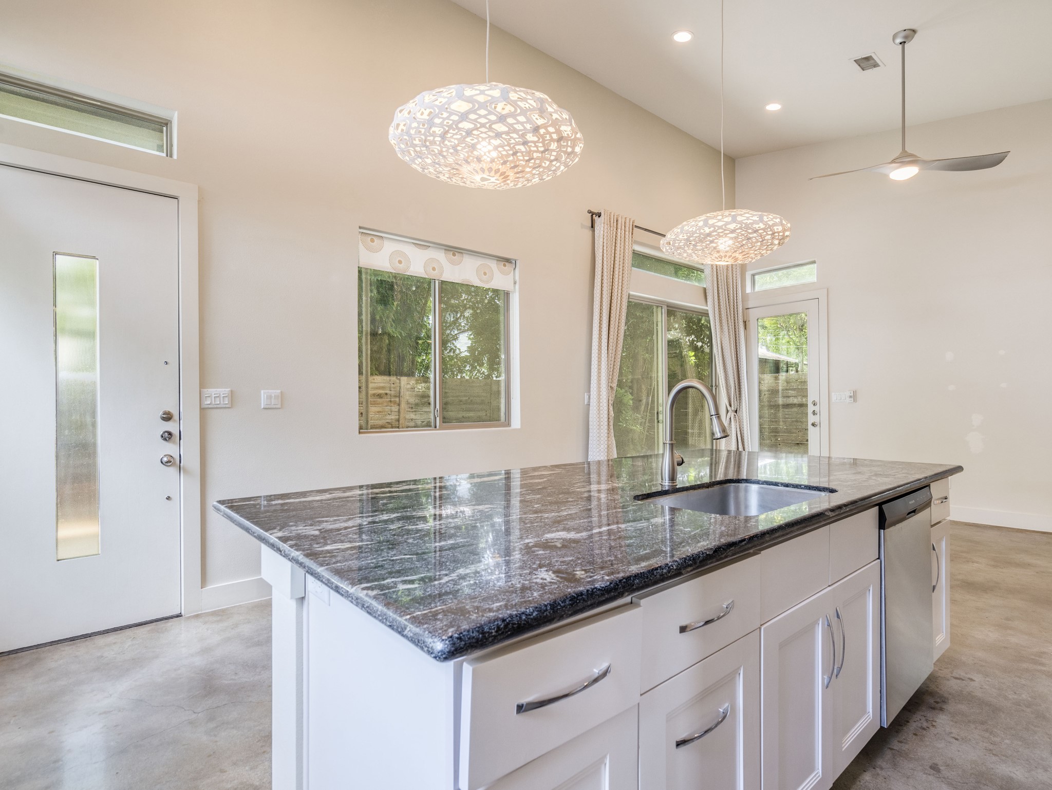 1404 Singleton Avenue, Unit B Austin, TX 78702 - Photo 4 of 21 A well-appointed kitchen island with sleek granite counters defines this bright, open space.