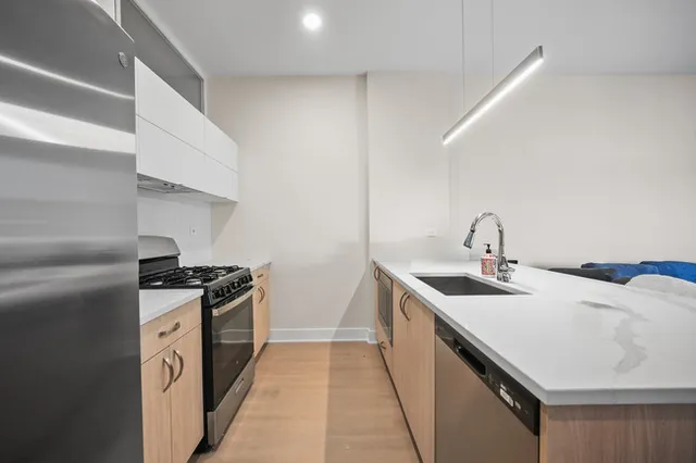 a kitchen with a sink stove and cabinets