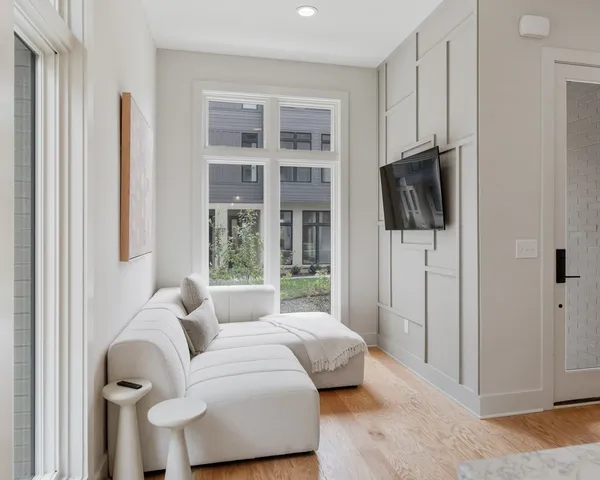 a bedroom with furniture and a flat screen tv