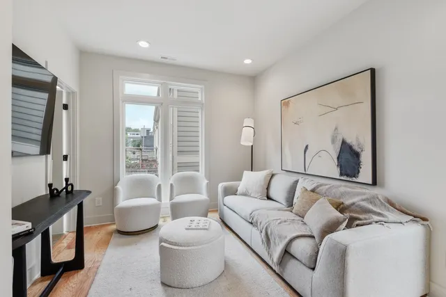 a living room with furniture and a large window