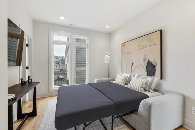 a bedroom with two beds and a mirror