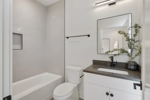 a bathroom with a sink a toilet and a mirror