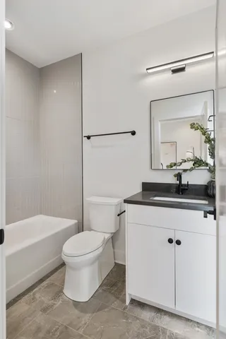 a bathroom with a sink a toilet and a mirror