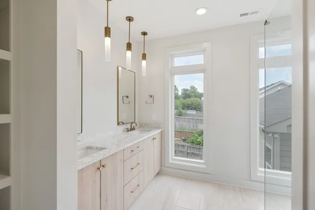a bathroom with a double vanity sink and a mirror