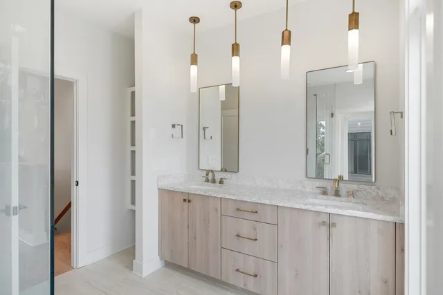 a bathroom with a double vanity sink and a mirror