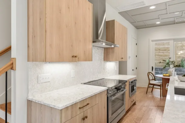 a kitchen that has a sink a stove and a table in it