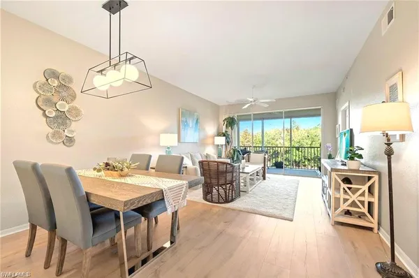 a living room with furniture a window and a chandelier