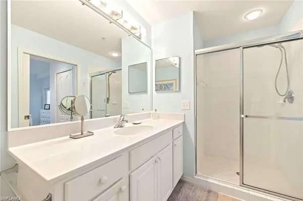 a bathroom with a sink double vanity and a mirror