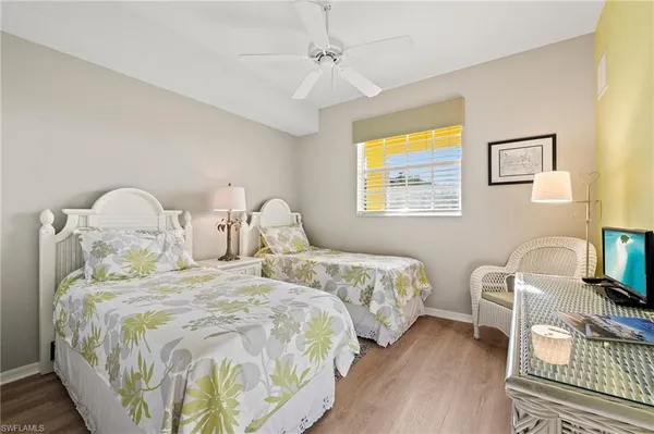 a bedroom with two beds and lamps