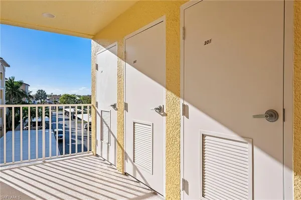 a view of a balcony with wooden floor and fence