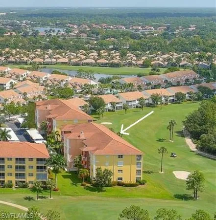 an aerial view of a city with lots of residential buildings and mountain view in back