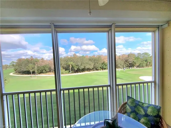 a view of a porch with a floor to ceiling window and outside view