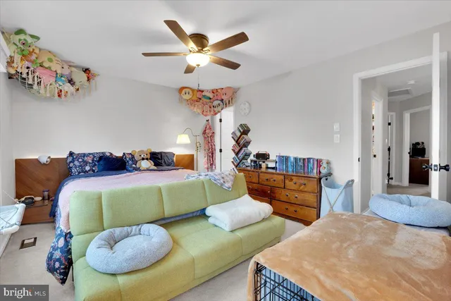 a bedroom with two beds and a chandelier