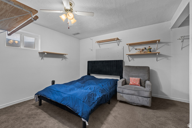 7659 State Street Midvale, UT 84047 - Photo 19 of 33 Carpeted room featuring a ceiling fan with integrated lighting, a functional window, and built-in shelving