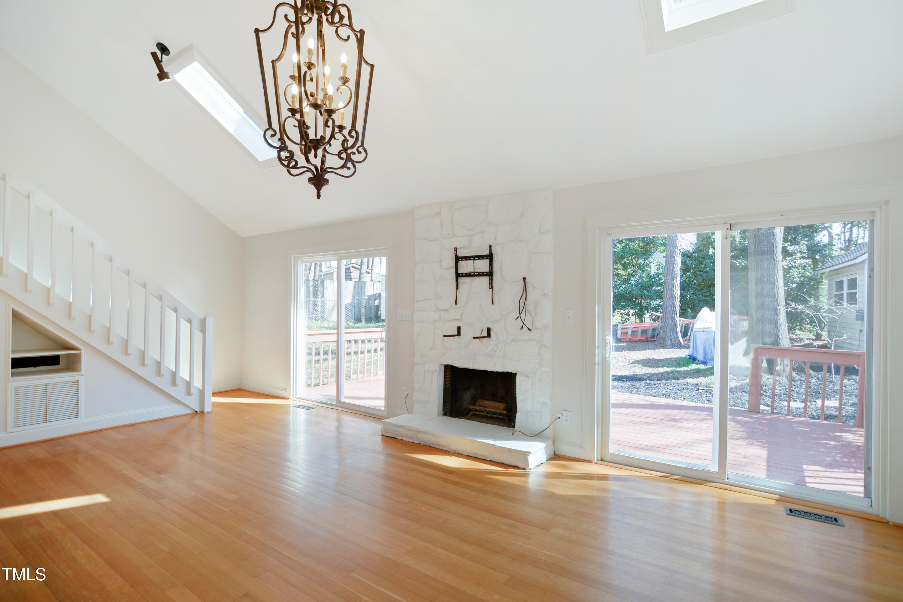 7216 Bluffside Court Raleigh, NC 27615 - Photo 3 of 22 a view of an empty room with wooden floor and a window