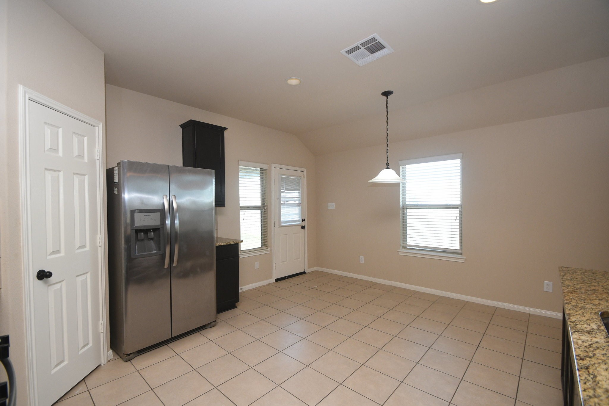 10015 Bitternut Hickory Lane Tomball, TX 77375 - Photo 11 of 36 a view of an empty room with window and chandelier fan