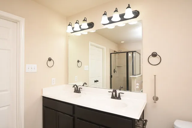 a bathroom with a sink vanity and mirror