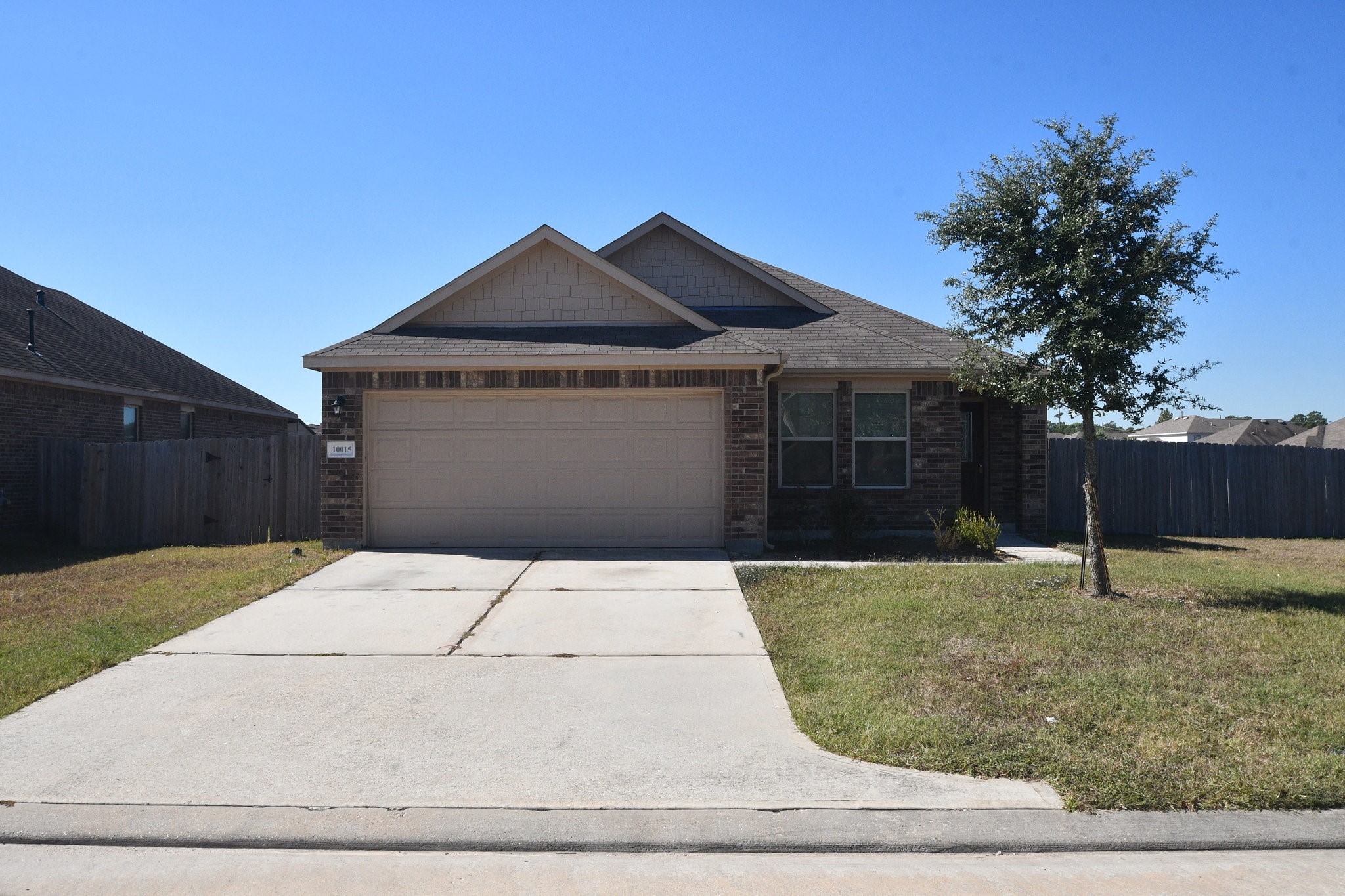 10015 Bitternut Hickory Lane Tomball, TX 77375 - Photo 2 of 36 a front view of a house with garden