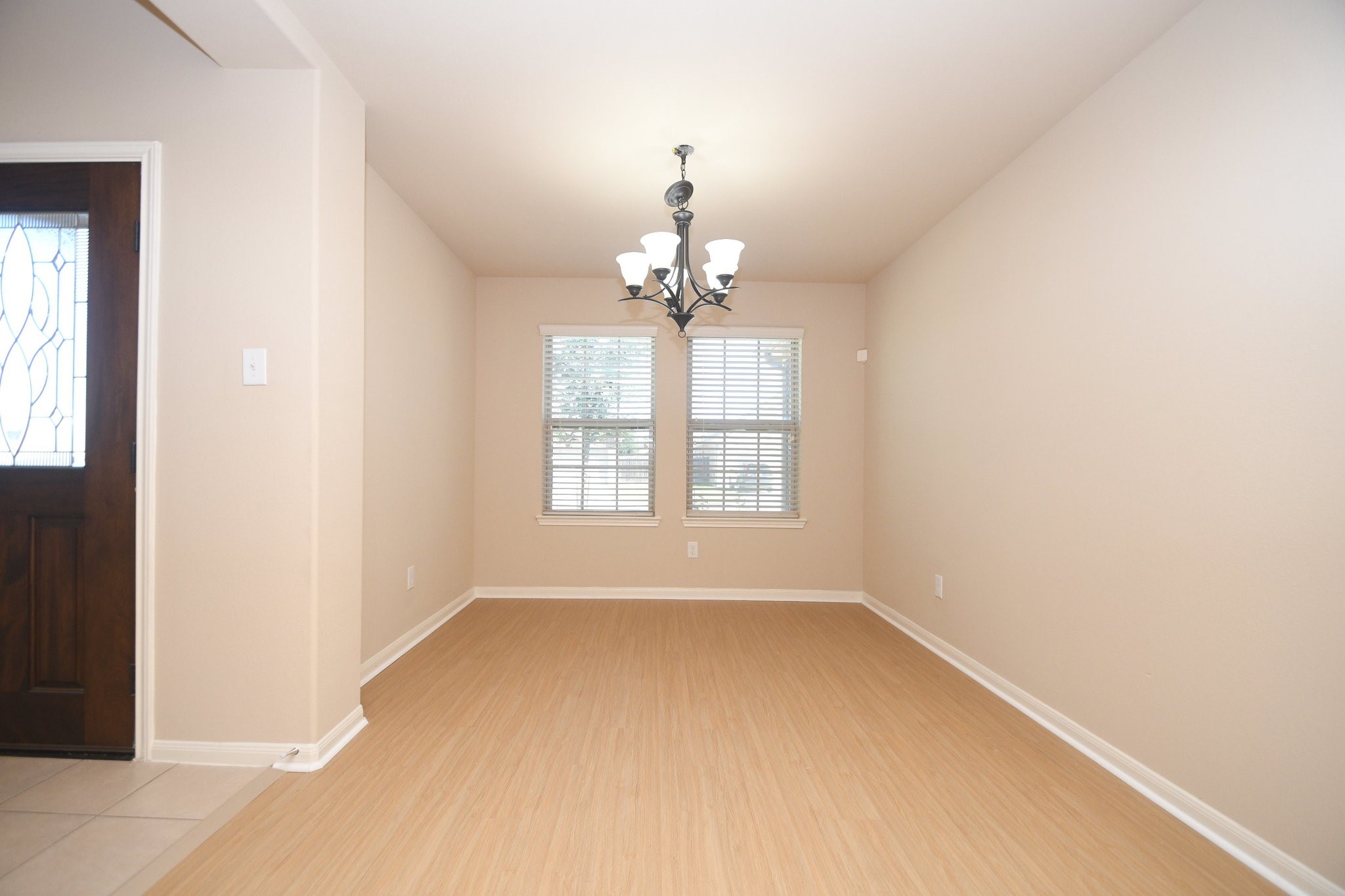 10015 Bitternut Hickory Lane Tomball, TX 77375 - Photo 4 of 36 wooden floor in an empty room with a window