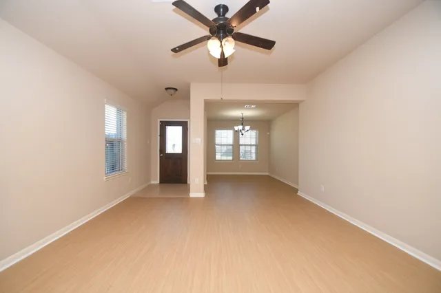 a view of a livingroom with a ceiling fan and window