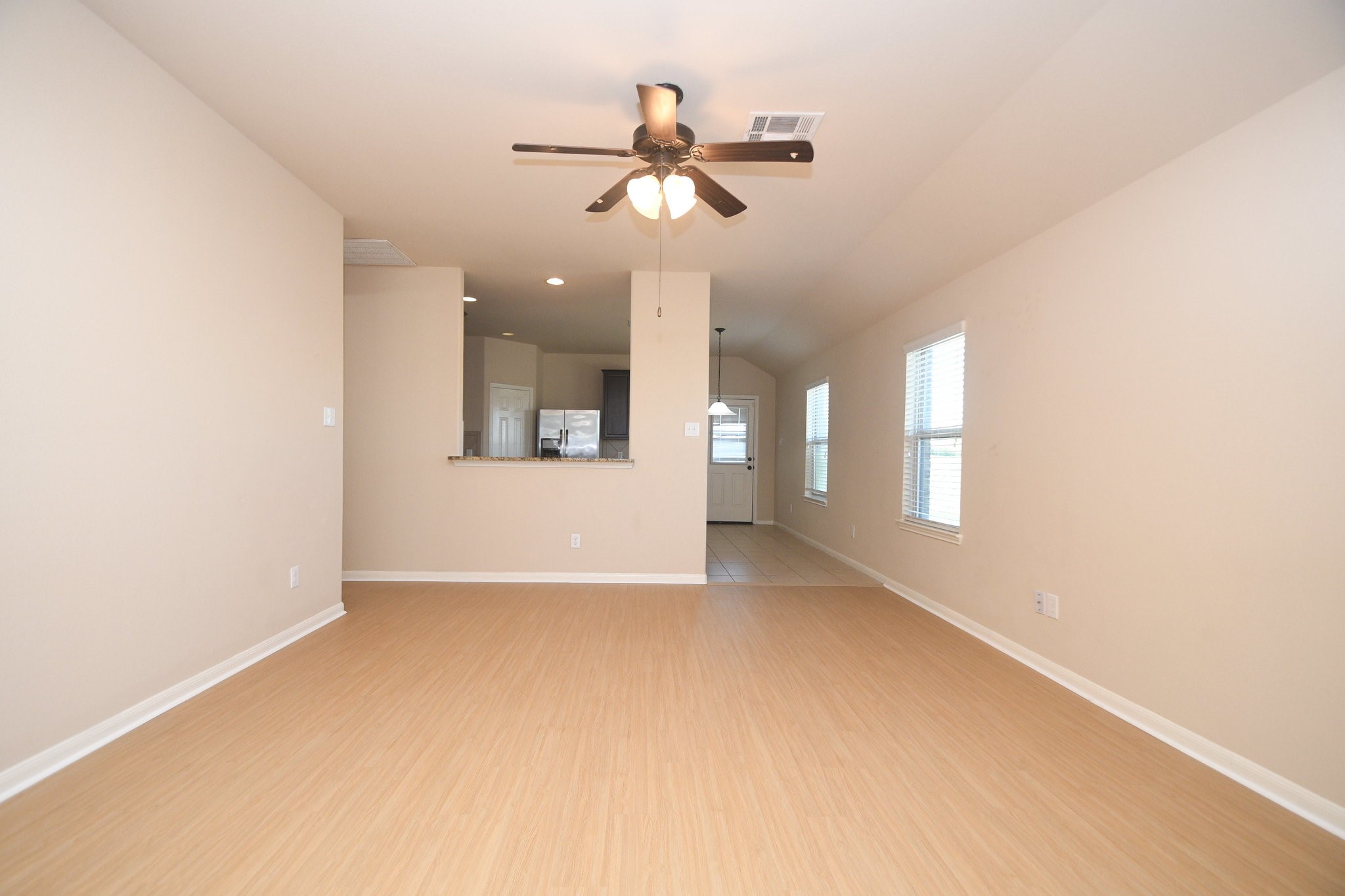 10015 Bitternut Hickory Lane Tomball, TX 77375 - Photo 8 of 36 a view of a livingroom with a ceiling fan and window
