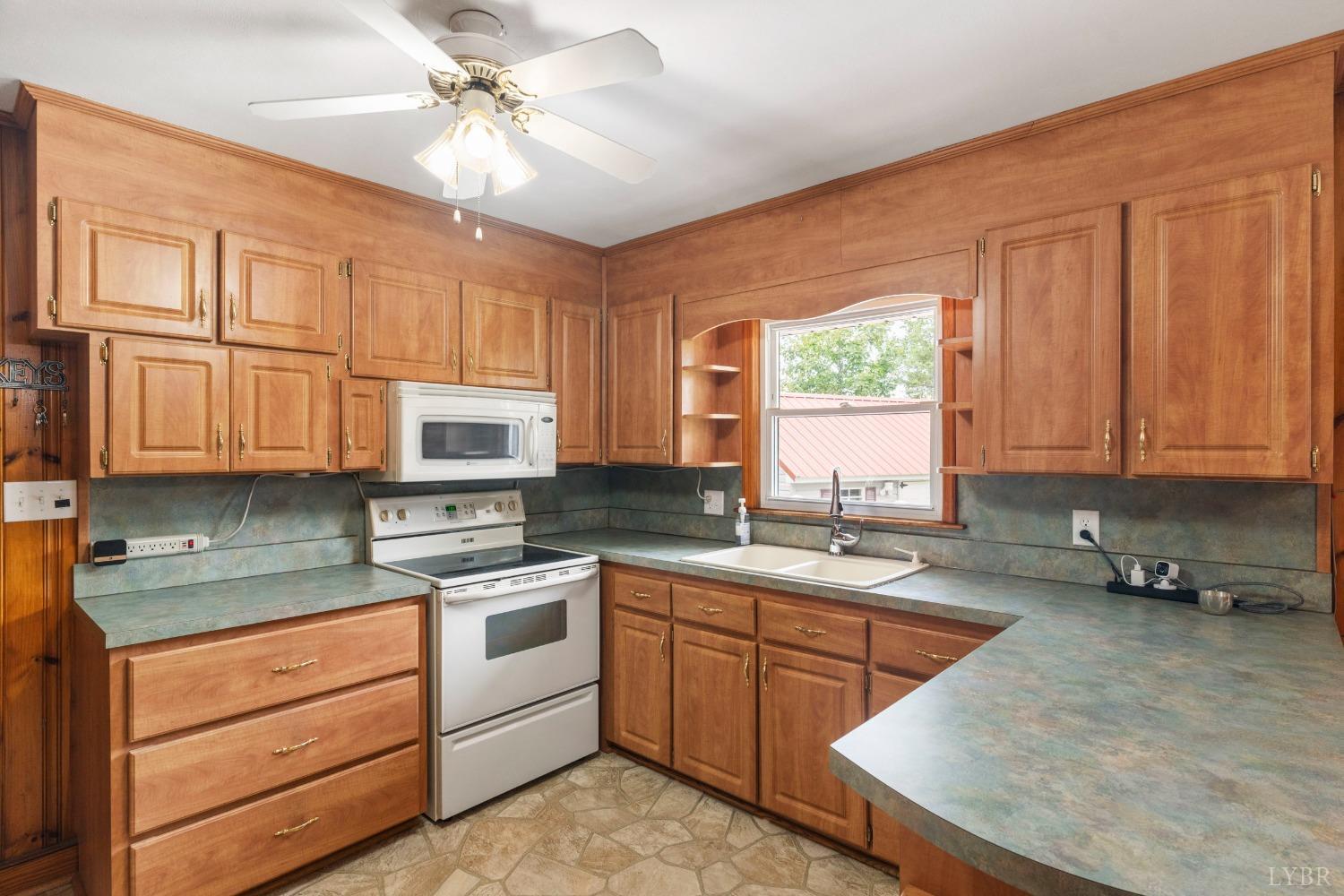 2920 Goode Station Road Goode, VA 24556 - Photo 9 of 50 a kitchen with stainless steel appliances granite countertop a sink stove and cabinets