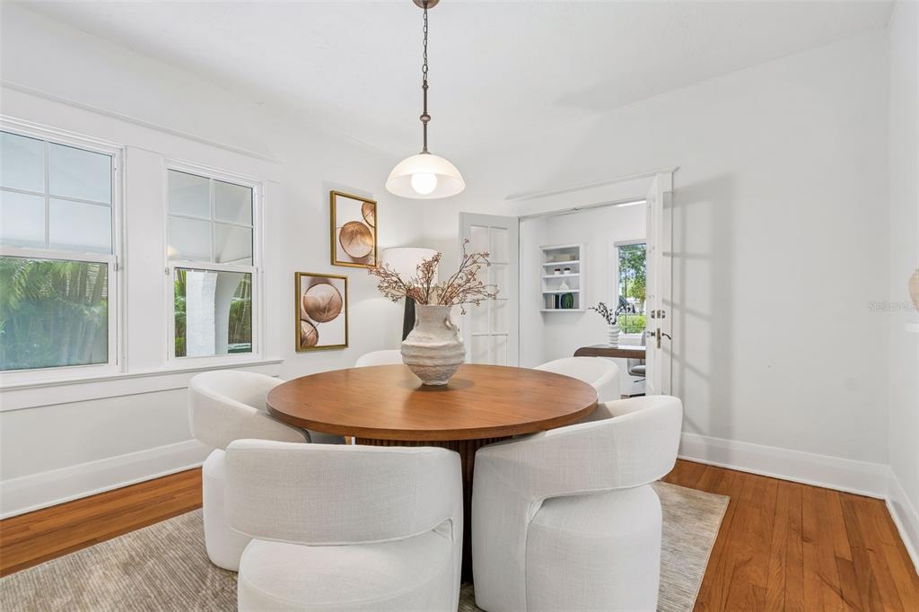 2434 West Prospect Road Tampa, FL 33629 - Photo 11 of 45 a dining room with wooden floor a chandelier a wooden table and chairs