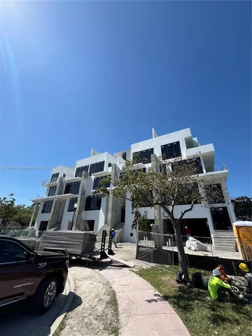 a roof deck with table and chairs a barbeque