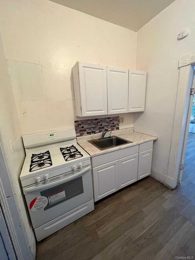 119 Chambers Street Newburgh, NY 12550 - Photo 12 of 18 a white stove top oven sitting inside of a kitchen