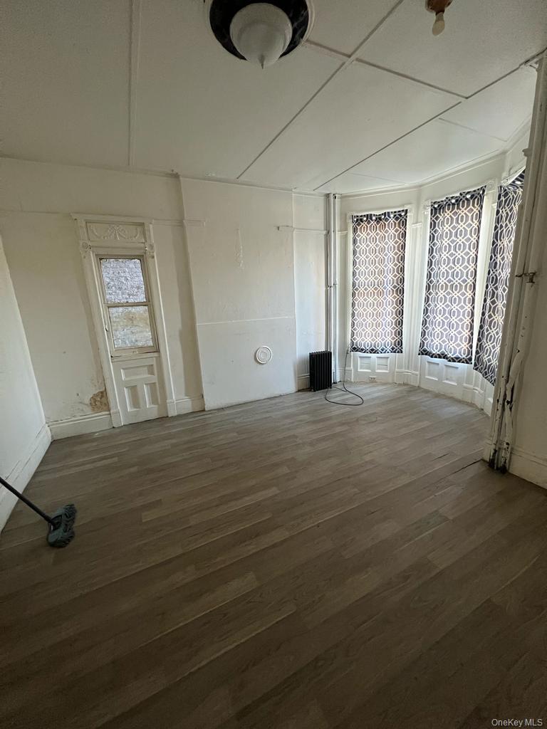 119 Chambers Street Newburgh, NY 12550 - Photo 16 of 18 a view of an empty room with window and wooden floor
