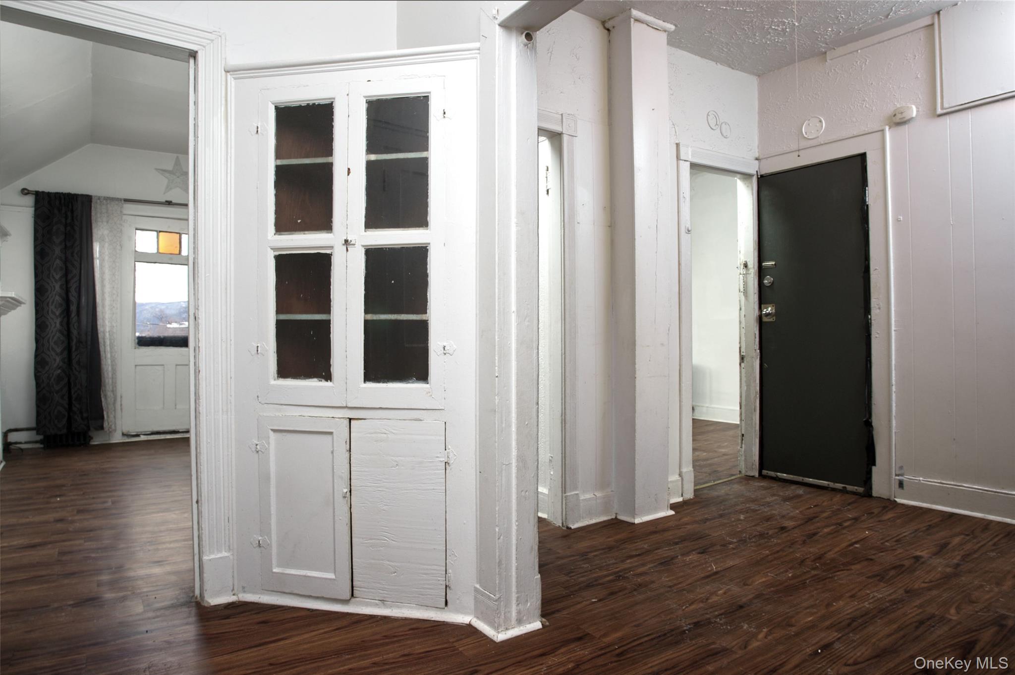 119 Chambers Street Newburgh, NY 12550 - Photo 2 of 18 a view of an empty room with wooden floor and windows